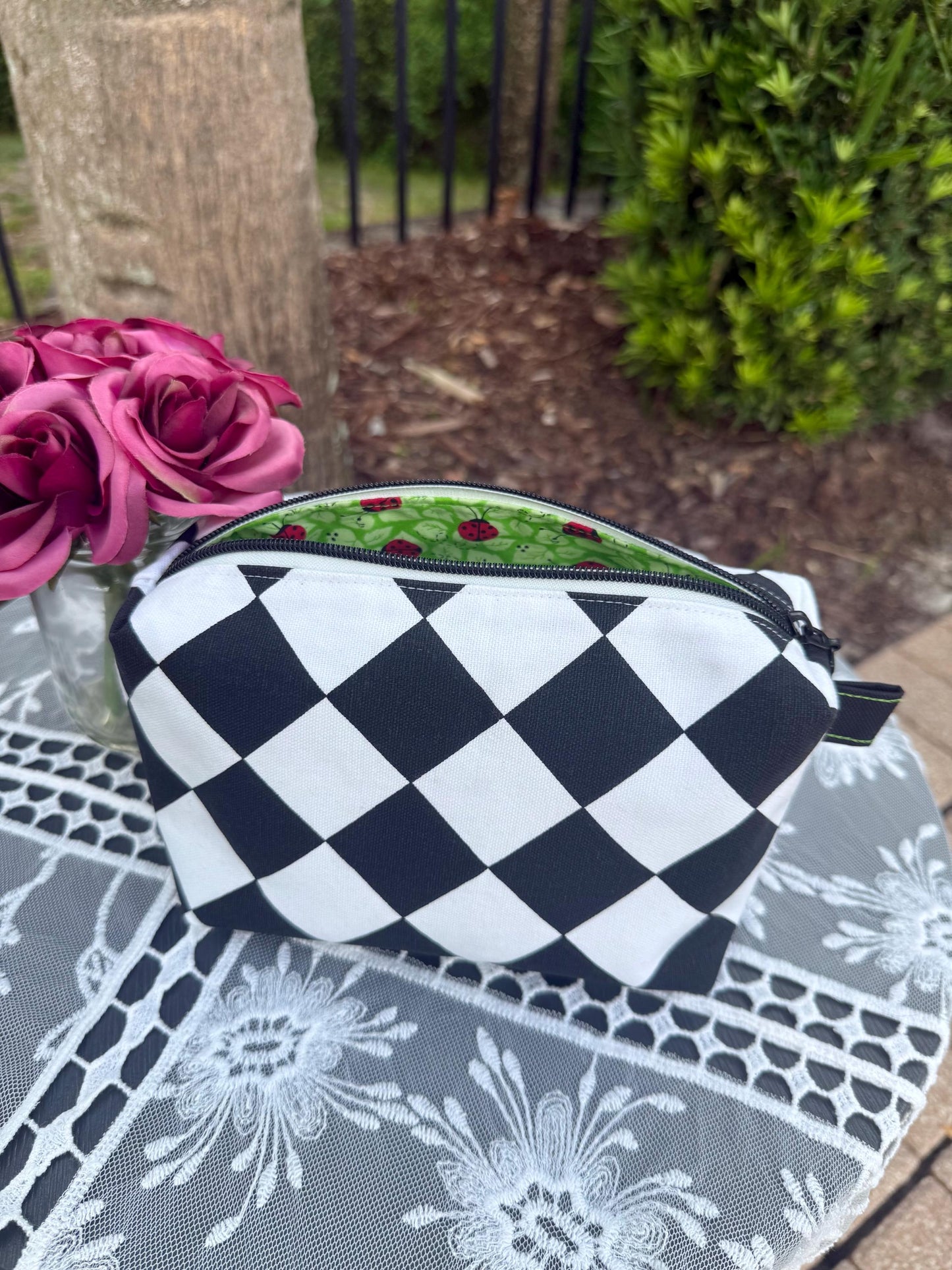 Cosmetic box pouch, green fabric lining with ladybugs, black and white zippered pouch