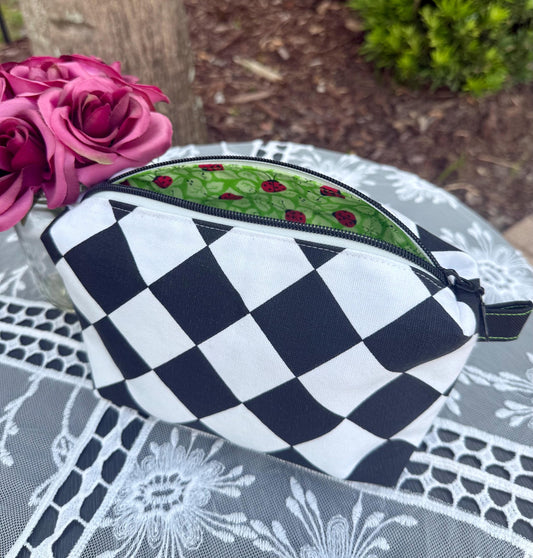 Cosmetic box pouch, green fabric lining with ladybugs, black and white zippered pouch