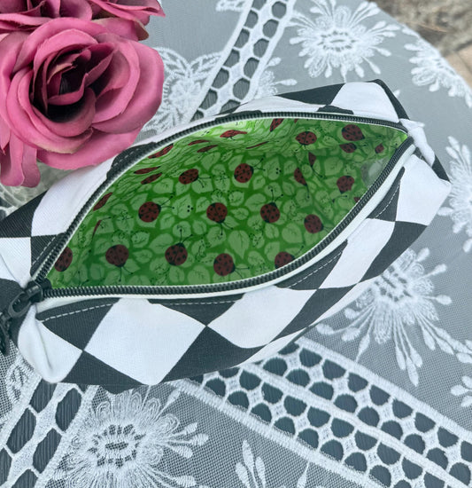 Cosmetic box pouch, green fabric lining with ladybugs, black and white zippered pouch